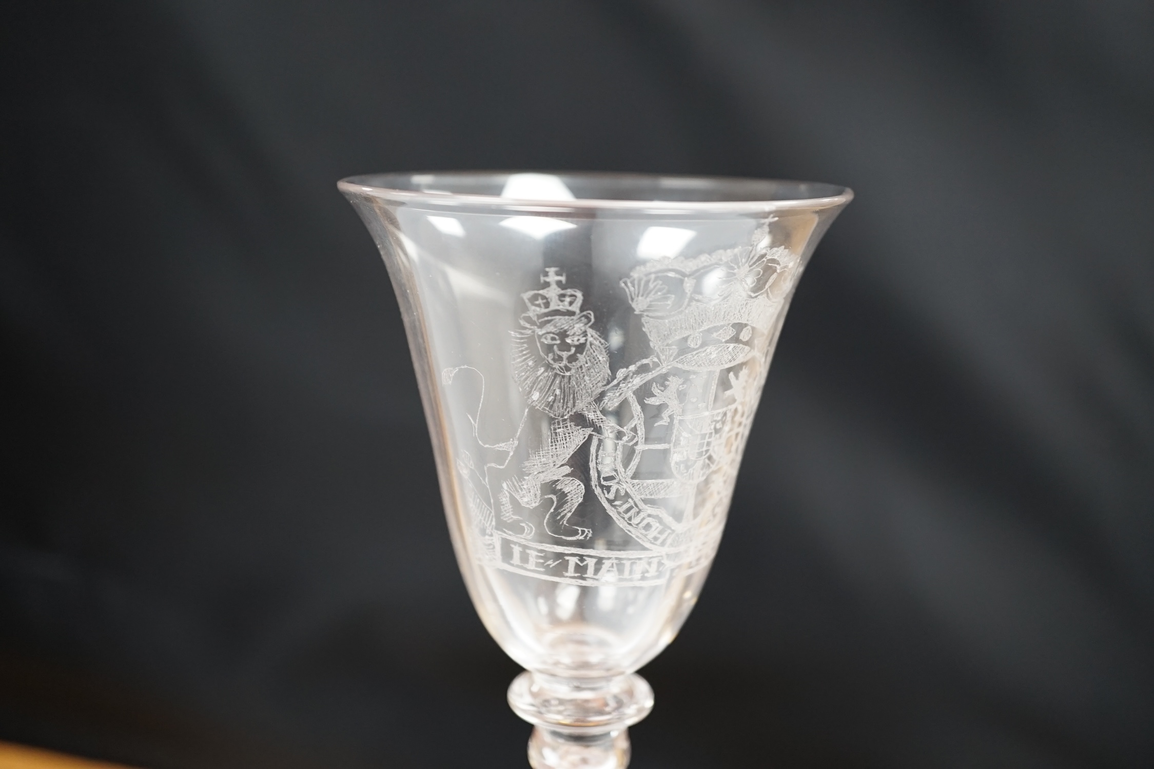 An 19th century diamond point engraved armorial glass, with knopped stem, air tears and rough pontil, 18cm